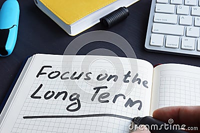 Man is writing focus on the long term. Stock Photo
