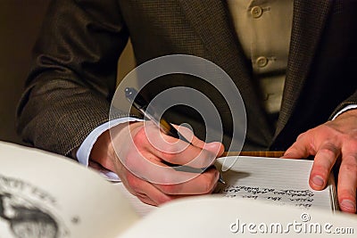 Man writing a letter in a journal Editorial Stock Photo