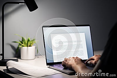 Man writing text document, essay or letter with laptop. Freelance writer, journalist or entrepreneur working late at night. Stock Photo