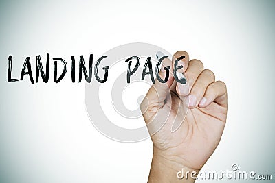 Man writing the text landing page Stock Photo