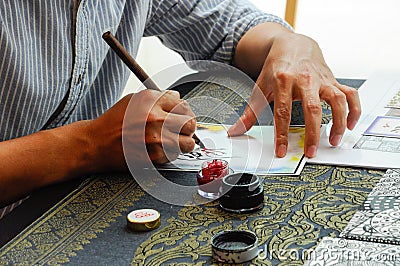 A man wrote an Arab calligraphy Editorial Stock Photo