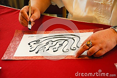 A man wrote an Arab calligraphy Editorial Stock Photo