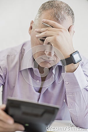 The man (businessman, manager, analyst, student) working with tables, graphs, diagrams, makes calculations at the table Stock Photo
