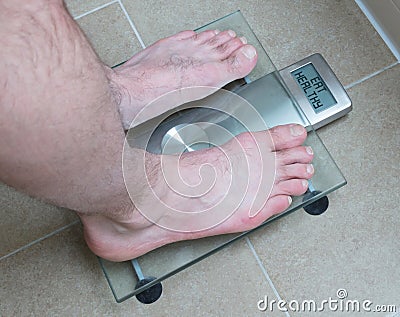 Man& x27;s feet on weight scale - Eat healthy Stock Photo