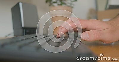 Man& x27;s hand starts typing on computer keyboard. Close-up, side view. Concept of beginning work, study, correspondence Stock Photo