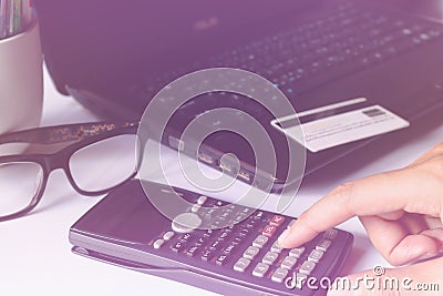 Man's hands using calculator for online shopping and credit card Stock Photo