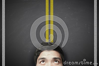 Man with yellow highway lines on the blackboard Stock Photo