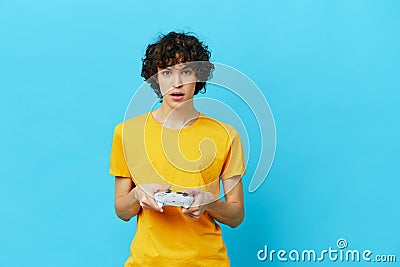 man yellow T-shirt with joystick video games technologies Stock Photo
