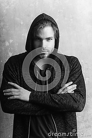 Man wearing grey hoodie with arms crossed Stock Photo