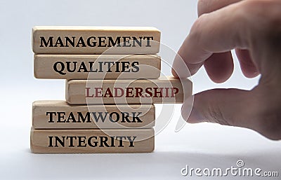 Management, qualities, leadership, teamwork and integrity text on wooden blocks with white background. Leadership Stock Photo