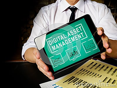 Manager holds tablet with Digital asset management data. Stock Photo