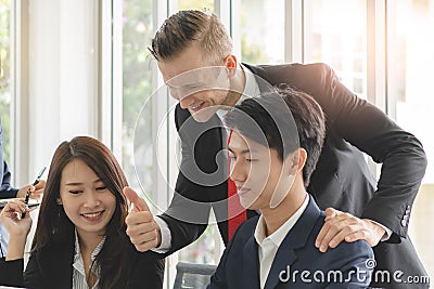 leader encourage team employee freshman during doing a good job project in office Stock Photo