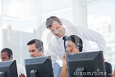 Manager listening to call centre employee Stock Photo