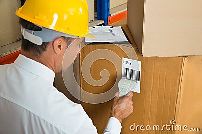 Manager Scanning Cardboard Box With Barcode Scanner Stock Photo