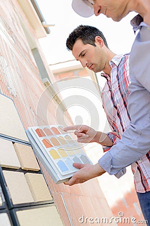manager and surveyor choosing house color Stock Photo