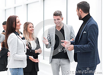 Manager telling about something to young employees. Stock Photo