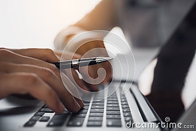 Manager is using the computer to record the information of those who apply for jobs Stock Photo