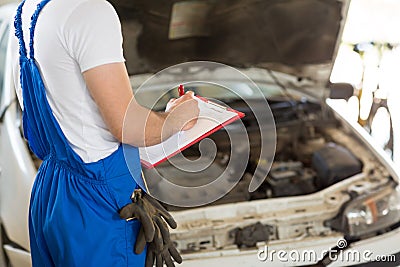 Manager writing on clipboard Stock Photo