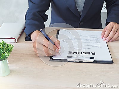 Managers are checking out the cover letter. By sitting on his desk. Resume concept Stock Photo