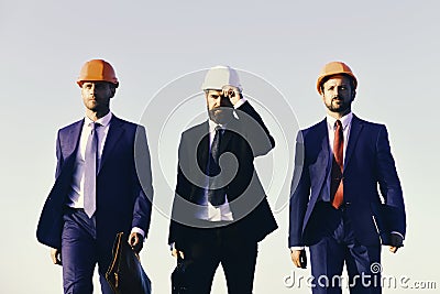 Managers hold folder and briefcases. Construction and business concept. Stock Photo