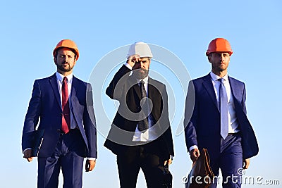 Managers hold folder and briefcases. Construction and business concept. Stock Photo