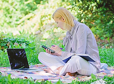 Managing business outdoors. Woman with laptop sit grass meadow. Business lady freelance work outdoors. Become successful Stock Photo