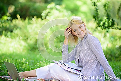 Managing business remote outdoors. Woman with laptop sit grass meadow. Best jobs to work remotely. Stay free with remote Stock Photo