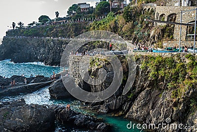 Manarola ITALY - 2 August 2023 - Cliff with tourists in promenade in viewpoint to the sea Editorial Stock Photo