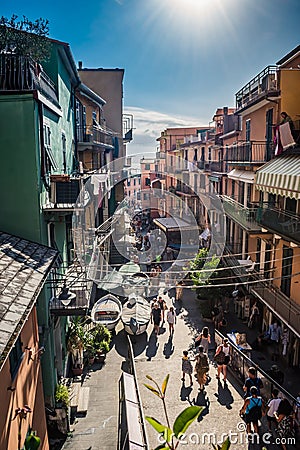 Manarola ITALY - 2 August 2023 - Perspective of the street with tourists and colorful houses Editorial Stock Photo