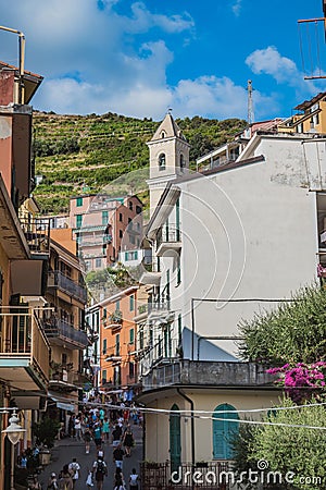 Manarola ITALY - 2 August 2023 - Street with tourists and colorful and picturesque houses Editorial Stock Photo