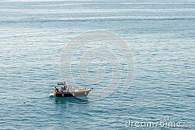 Tourist boat off the coast at Manarola Liguria Italy on April 20, 2019. Three unidentified Editorial Stock Photo