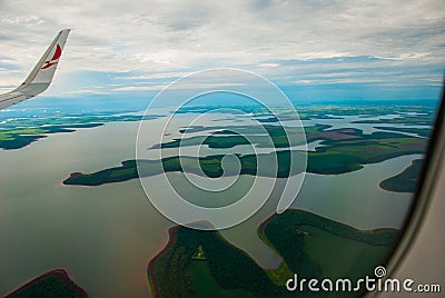 Manaus, Amazonas, Brazil: Top view of the river. Beautiful landscape from the window of the airplane Editorial Stock Photo