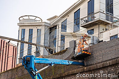 Masonry repair work carried out by young bricklayer. Editorial Stock Photo