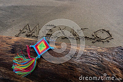 Mandala Eye of God Mexico Huichol Crafts on trunk in Sayulita beach. Stock Photo