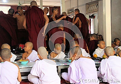 MANDALAY, MYANMAR - DECEMBER 18. 2015: Buddhist monks having breakfast at Mahagandayon Monastery Editorial Stock Photo
