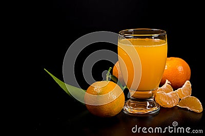 Mandarin juice on black background Stock Photo