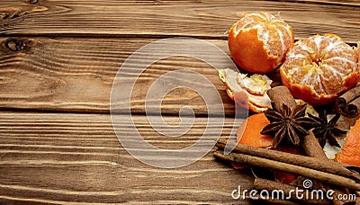 Mandarin orange slices cinnamon sticks and star anise on wooden background Stock Photo