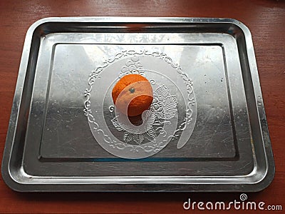 Mandarine on iron tray on wooden table Stock Photo