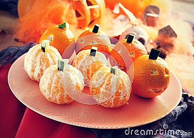 Mandarines ornamented as Halloween pumpkins Stock Photo