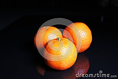 Mandarins. Mandarin citrus orange fruit mandarins on black reflective studio background. black shiny mirror mirrored back Stock Photo