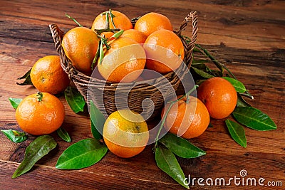 Mandarins tangerines basket organic fruits on dark wooden background Stock Photo