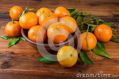 Mandarins tangerines in brown ceramic bowl Stock Photo