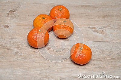 Mandarins on a wooden table with one in focus Stock Photo