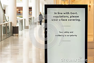 Mandatory face masks at indoors venues. In line with Government regulations, please wear a face covering Stock Photo