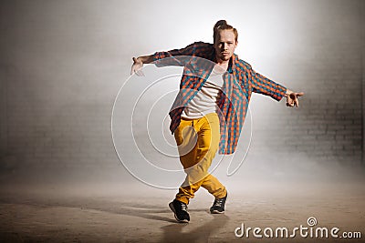 Manful guy with fashionable clothers dancing on foggy weather on the street Stock Photo