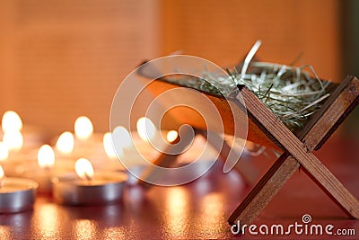 Manger nativity scene candles and bible in night abstract background Stock Photo