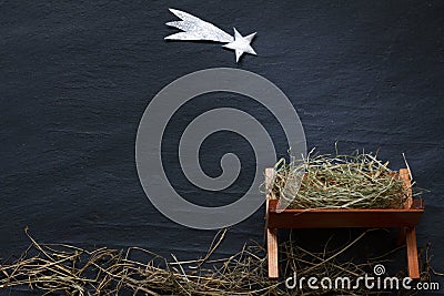 Manger and star of Bethlehem abstracy christmas background nativity scene on black marble Stock Photo