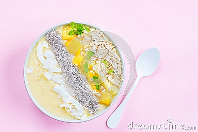 Mango, Banana, Pineapple and Oatmeal Smoothie in the Bowl Stock Photo