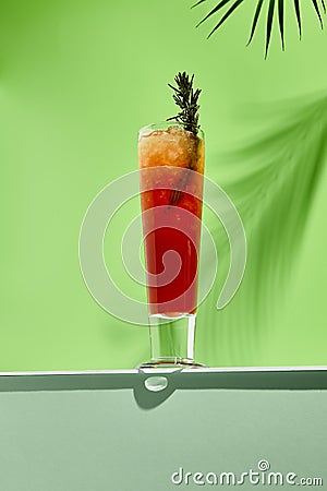 Mango and berries lemonades drink on white table. Green wall in sunlight with palm leaf hard shadow. Summer, tropic, fresh drink Stock Photo
