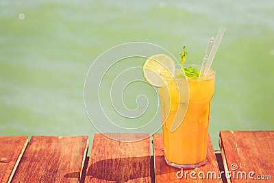 Mango mojito on the wooden pier. Concept of luxury tropical vacation. Classic cocktail Stock Photo